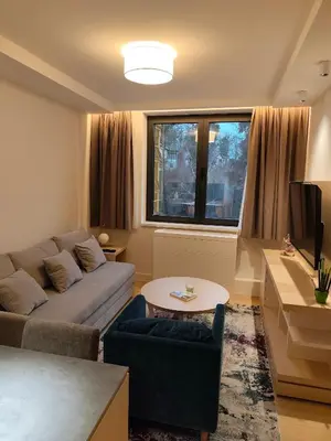 a living room with a couch and a table at ZEPTERME Promenada - Šetalište in Vrnjačka Banja