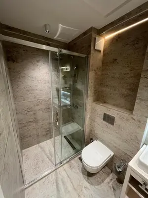 a bathroom with a shower and a toilet and a sink at ZEPTERME Promenada - Šetalište in Vrnjačka Banja