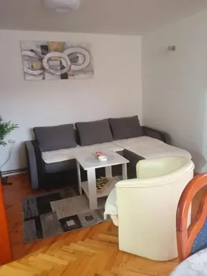 a living room with a couch and a table at Apartmani Milica in Kraljevo