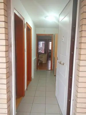 a hallway of a house with a door and a room at Apartmani Milica in Kraljevo