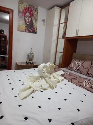 a bedroom with a bed with a towel on it at Apartmani Milica in Kraljevo