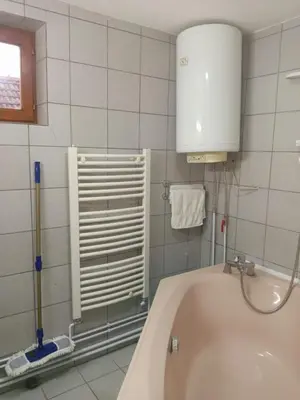 a bathroom with a bath tub and a sink at Apartmani Milica in Kraljevo