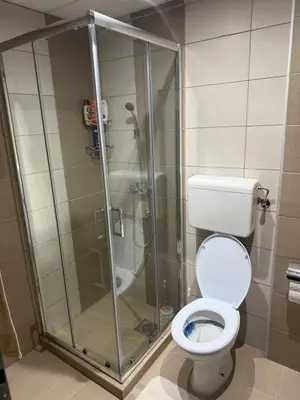 a bathroom with a toilet and a glass shower at Apartman Delux in Soko Banja
