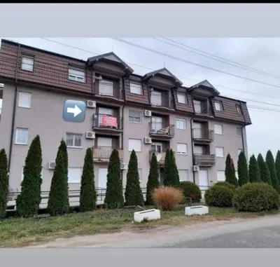 a large building with a sign on the side of it at Apartman Delux in Soko Banja