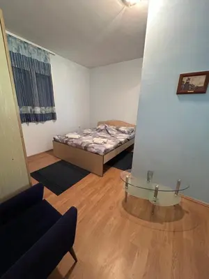 a small room with a bed and a glass table at Kuća Kostić in Gornja Toponica