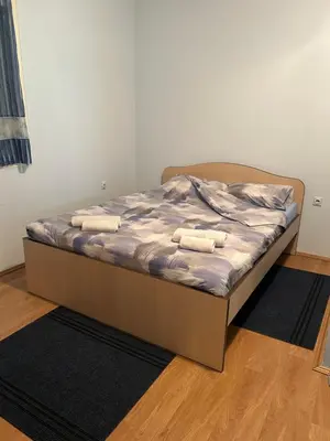 a bed with two towels on it in a bedroom at Kuća Kostić in Gornja Toponica