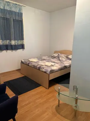 a small room with a bed and a glass table at Kuća Kostić in Gornja Toponica