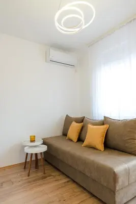 a living room with a couch and a table at Apartman Stevanovic in Vrnjačka Banja