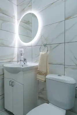 a white bathroom with a toilet and a sink at Apartman Stevanovic in Vrnjačka Banja