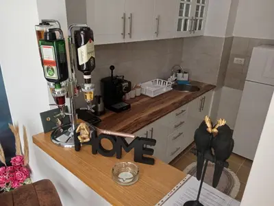 a kitchen with a counter with a love sign on it at Secret Spa Nis in Niš