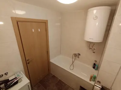 a bathroom with a bath tub and a sink at Secret Spa Nis in Niš