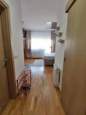 an empty room with a bed and a wooden floor at Secret Spa Nis in Niš
