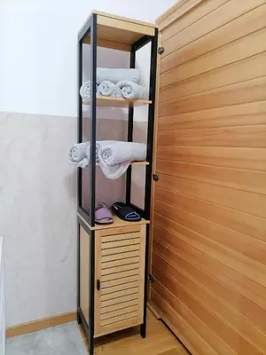 a closet with a wooden door and towels at Secret Spa Nis in Niš