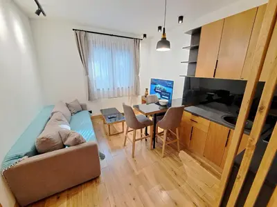 a small living room with a couch and a table at Casa di legno apartman 3,6,9 in Kopaonik