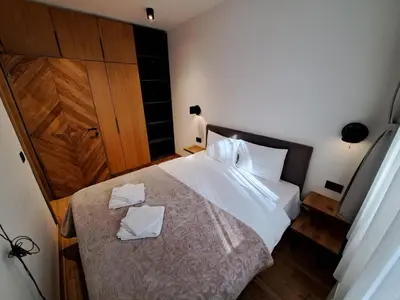 a bedroom with a bed with two white pillows on it at Casa di legno apartman 3,6,9 in Kopaonik