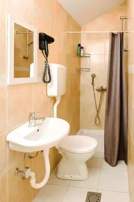 a bathroom with a toilet and a sink and a phone at Stan na dan Crystal in Paraćin