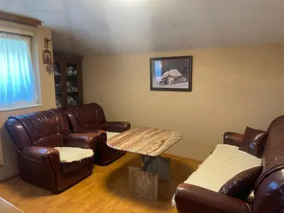 a living room with leather furniture and a table at Apartman Janković in Paraćin