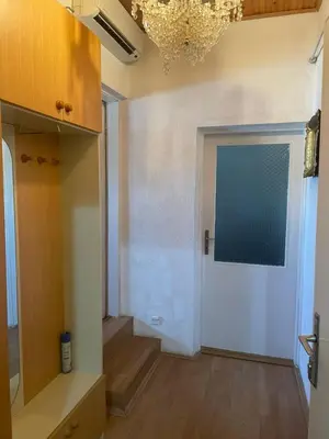 a living room with a door and a chandelier at Apartman Janković in Paraćin