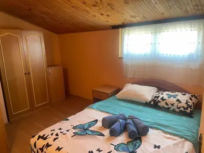 a bedroom with a bed with blue towels on it at Apartman Janković in Paraćin
