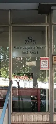 a window of a restaurant with a table in it at Apartman Janković in Paraćin