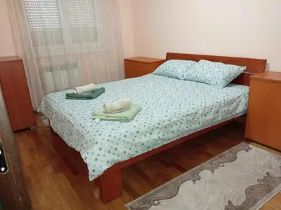 a bedroom with a bed with two towels on it at Apartman Ilić 1 in Vrnjačka Banja
