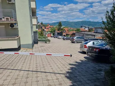 a pole laying on the ground in a parking lot at Apartman Ilić 1 in Vrnjačka Banja