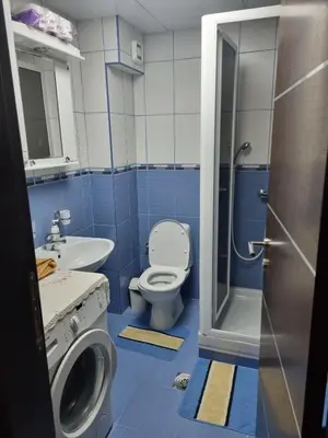 a blue bathroom with a toilet and a sink at Apartman Ilić 1 in Vrnjačka Banja