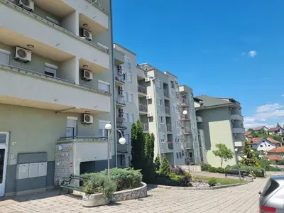 a row of apartment buildings on a street at Apartman Ilić 1 in Vrnjačka Banja