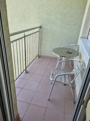 a small table and a chair on a balcony at Apartman Ilić 1 in Vrnjačka Banja