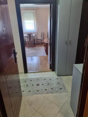 a door leading into a living room with a rug at Apartman Ilić 1 in Vrnjačka Banja