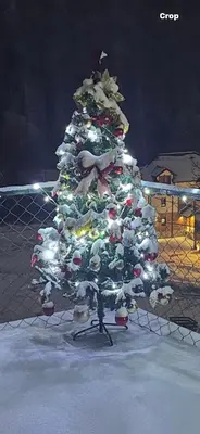 a christmas tree is decorated with ornaments at Apartmani Stankovic in Crni Vrh