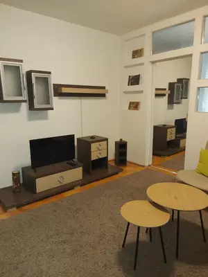 a living room with two tables and a flat screen tv at Katarina in Niš