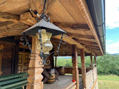 a light on the front porch of a log cabin at Brvnara 