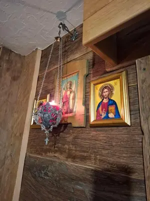 a room with paintings on the wall and a chandelier at Brvnara 
