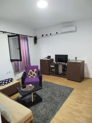 a living room with a couch and a purple chair at Milić in Jagodina