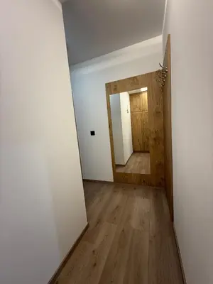an empty hallway with a door and a mirror at Four seasons in Vrnjačka Banja