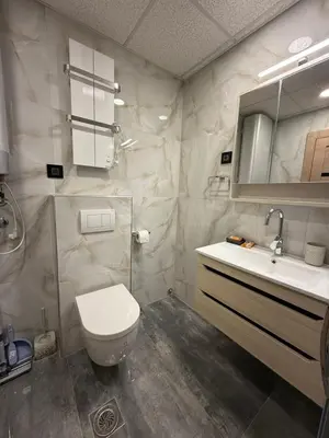 a bathroom with a toilet and a sink and a mirror at Four seasons in Vrnjačka Banja