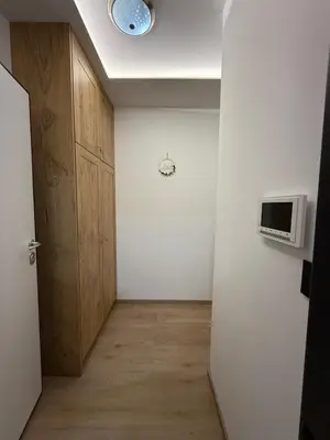 a room with a hallway with a door and a microwave at Four seasons in Vrnjačka Banja