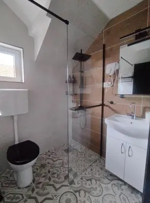 a bathroom with a shower and a toilet and a sink at Top 4 Sobe, Rooms - Near the airport in Niš