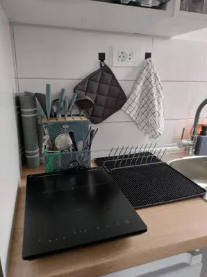 a kitchen counter with a black cutting board and a sink at Top 4 Sobe, Rooms - Near the airport in Niš