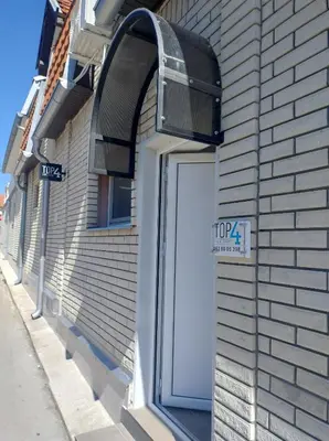 a door to a building with a sign on it at Top 4 Sobe, Rooms - Near the airport in Niš