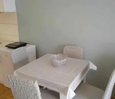 a white table with two chairs and a bowl on it at Leon Apartman in Vrnjačka Banja