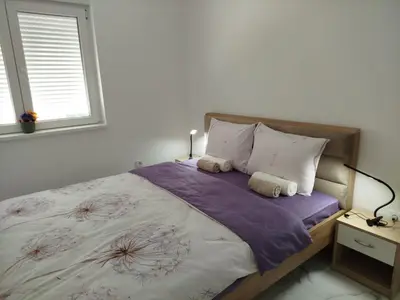 a bedroom with a bed with two towels on it at Vista MDD in Soko Banja