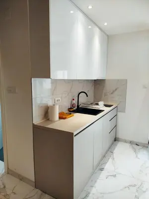 a kitchen with white cabinets and a sink at Vista MDD in Soko Banja
