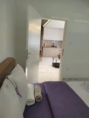 a bedroom with a bed with two towels on it at Vista MDD in Soko Banja