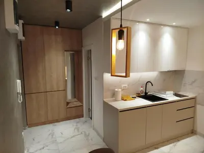 a kitchen with white cabinets and marble counter tops at Vista MDD in Soko Banja