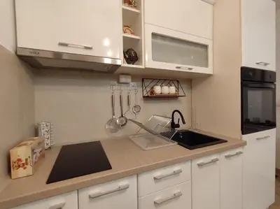 a kitchen with white cabinets and a sink at Apartman Jeca in Vrnjačka Banja