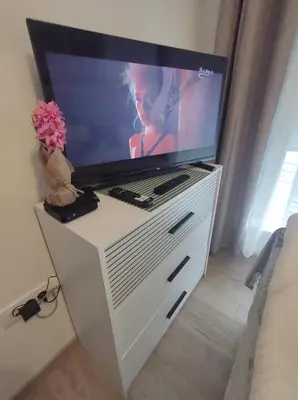 a television on a white dresser with a tv on it at Apartman Jeca in Vrnjačka Banja