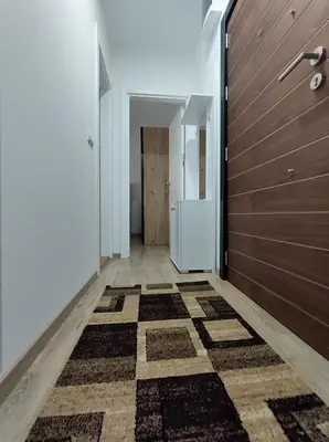a hallway with a door and a checkered floor at Apartman Jeca in Vrnjačka Banja