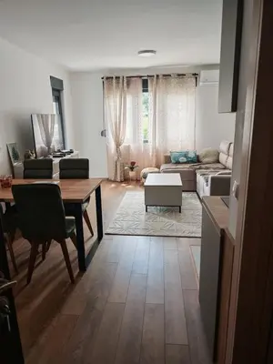 a living room with a table and a couch at Grabak B3 in Vrnjačka Banja